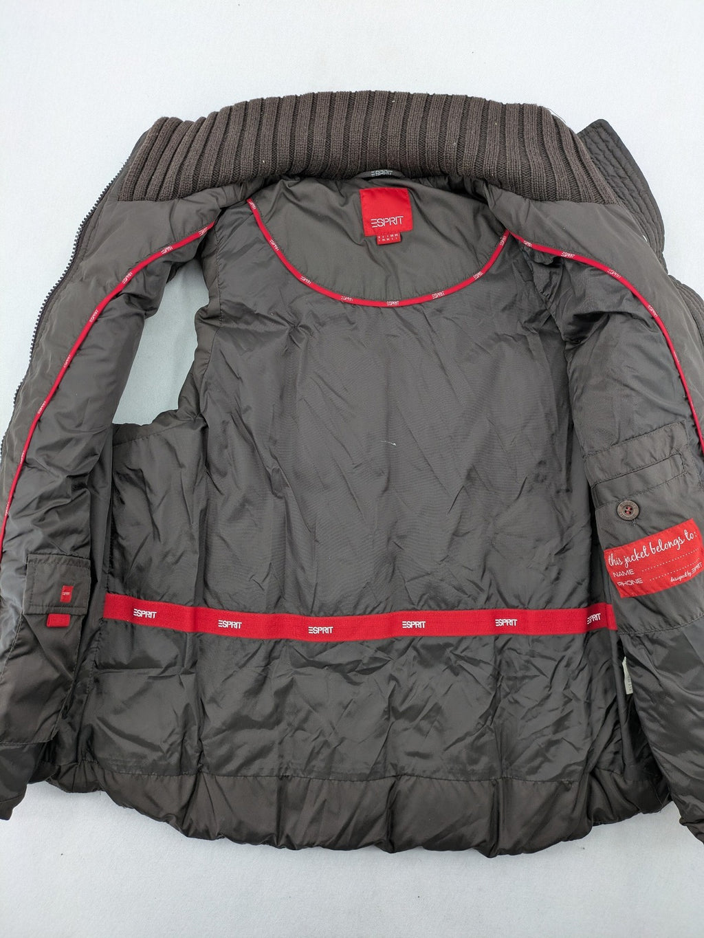 Esprit brown puffer vest with high ribbed collar and zip button closure.