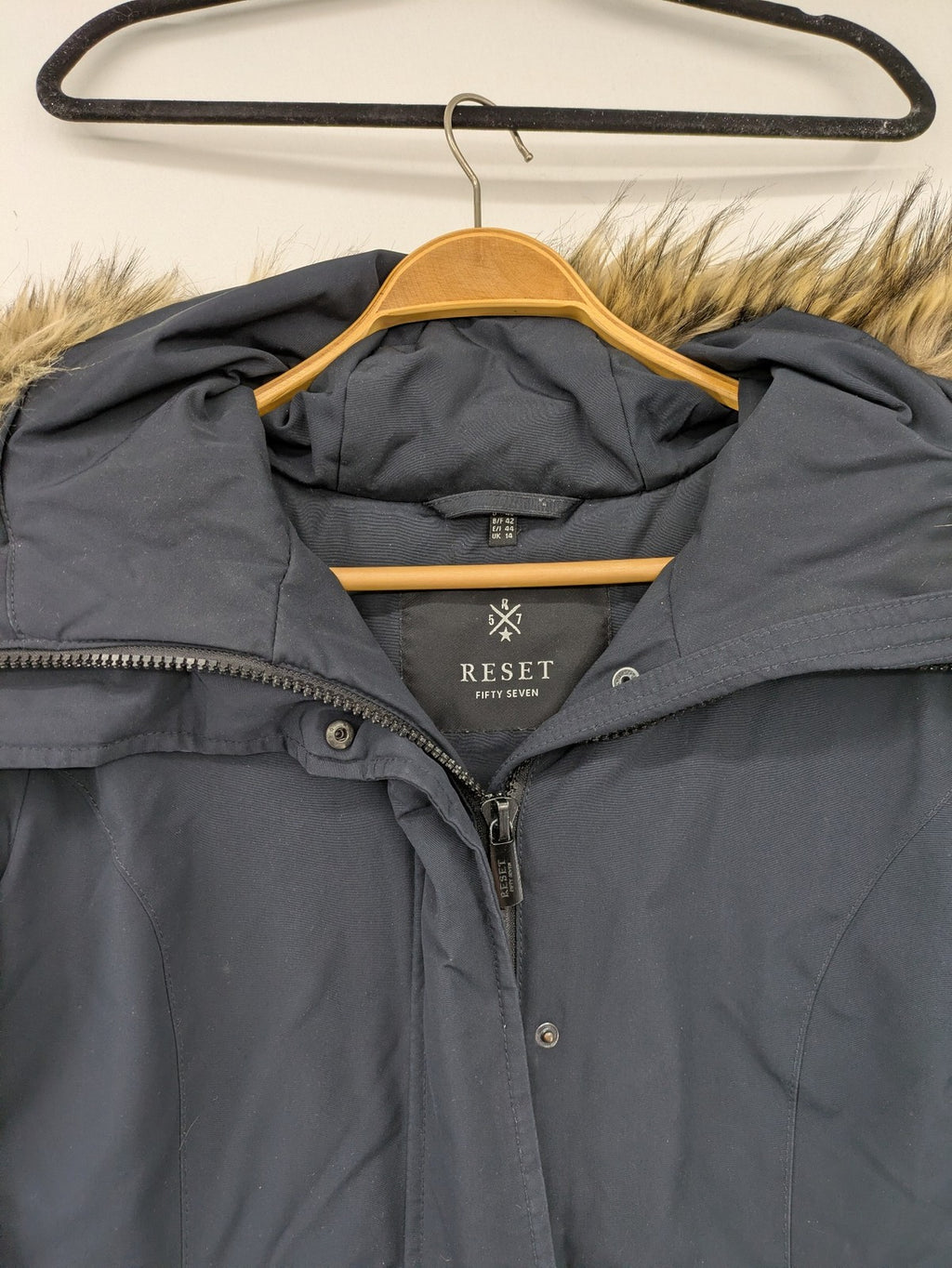 Reset Fifty Seven cream puffer coat with faux fur hood and down insulation.