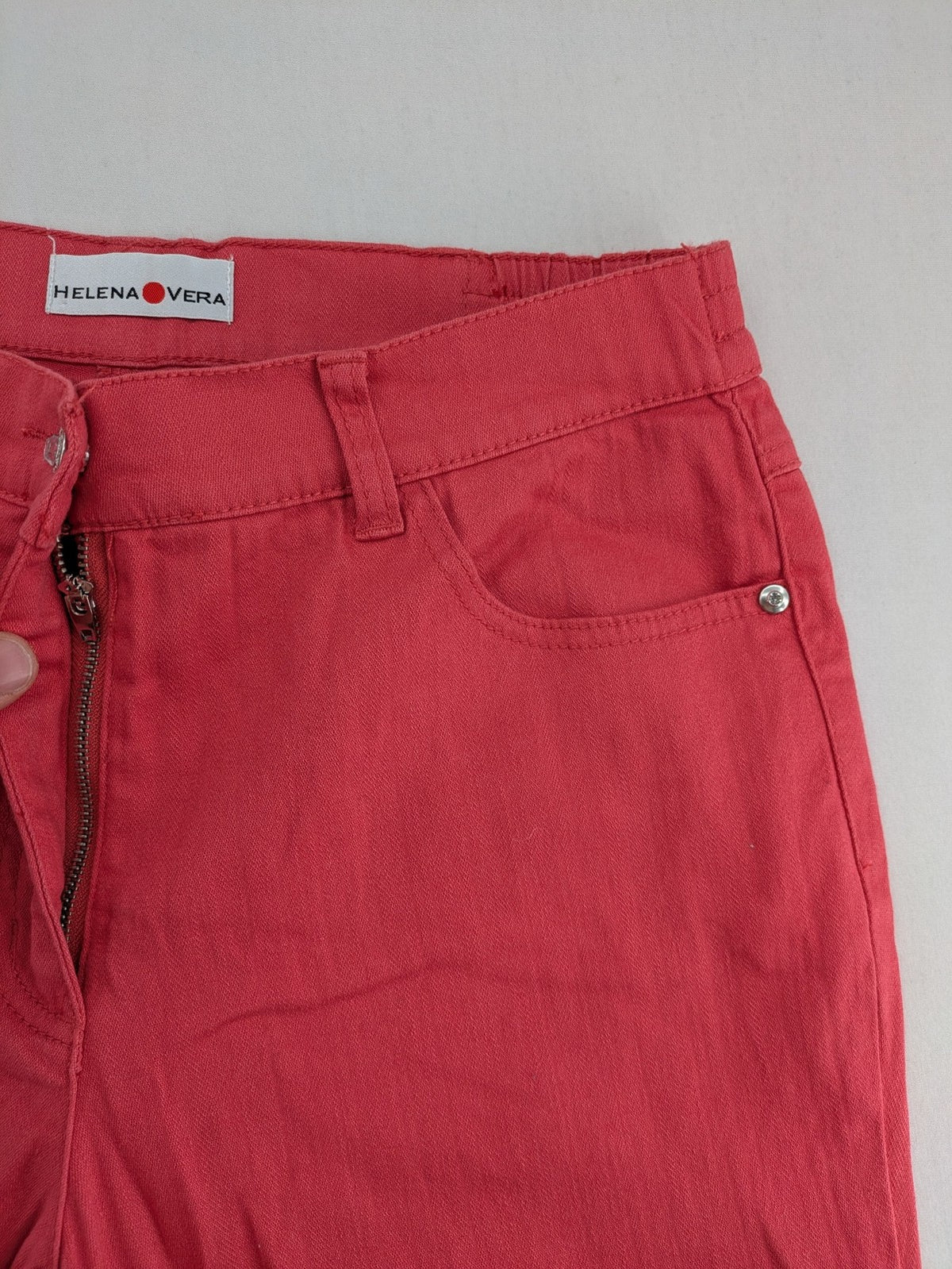 Helena Vera red straight jeans with elastic waistband and rhinestone details on pockets.