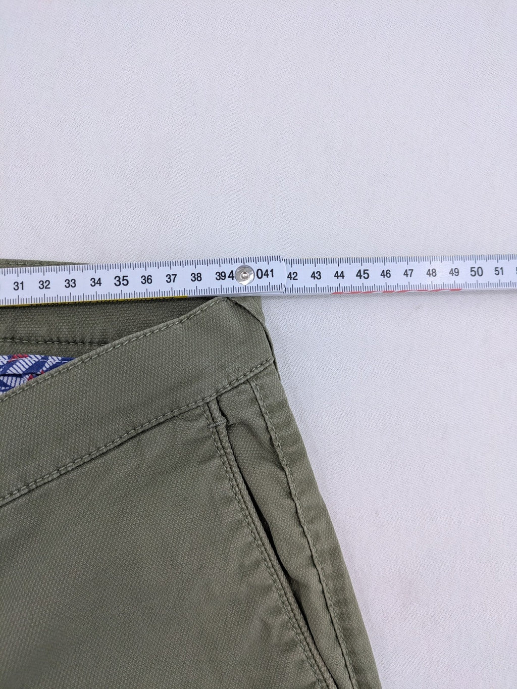 BRAX green chino pants flat-front design with zipper and buttoned back pockets.