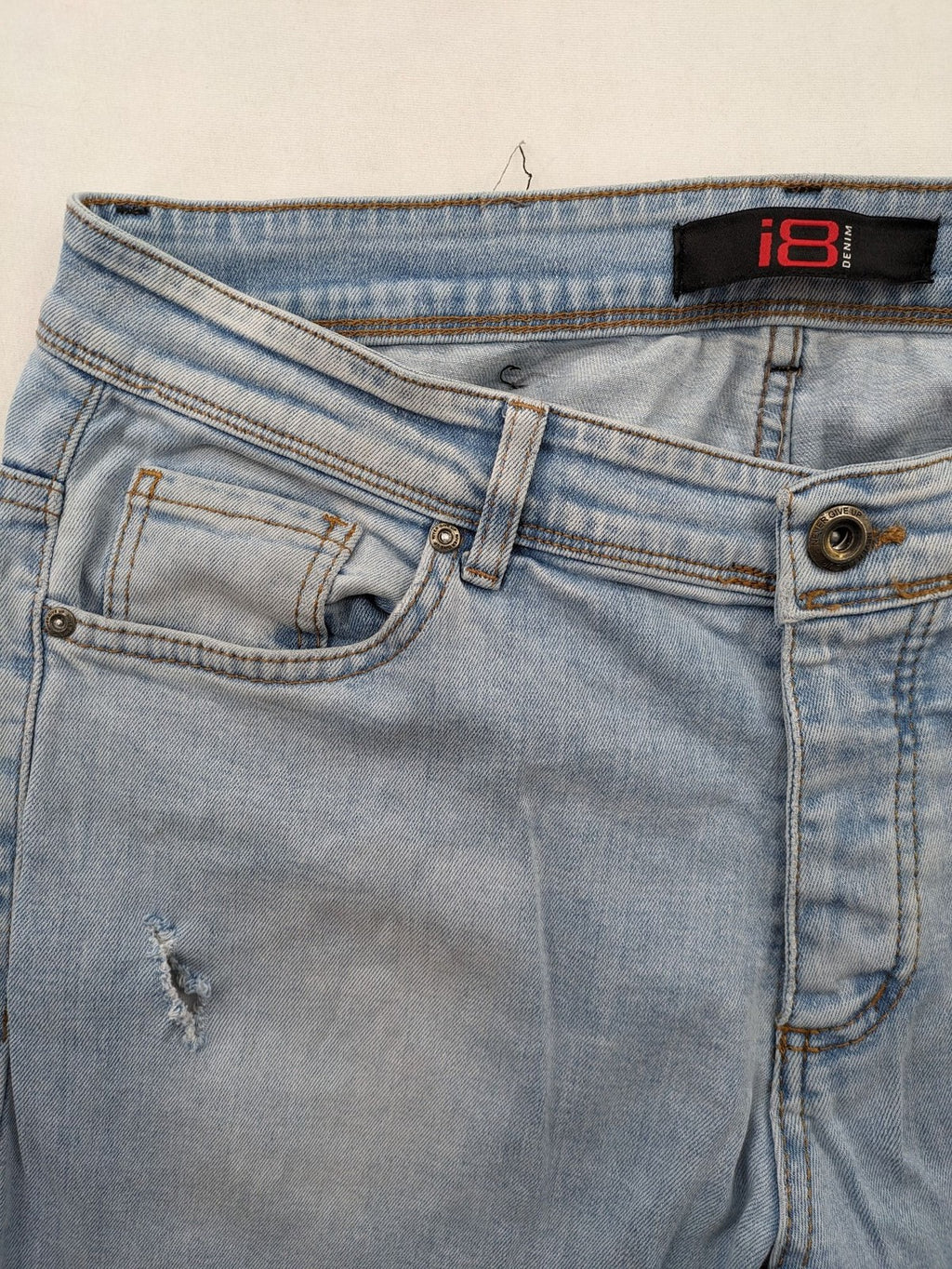 i8 Denim blue straight jeans destroyed look with frayed hems and classic button fly.