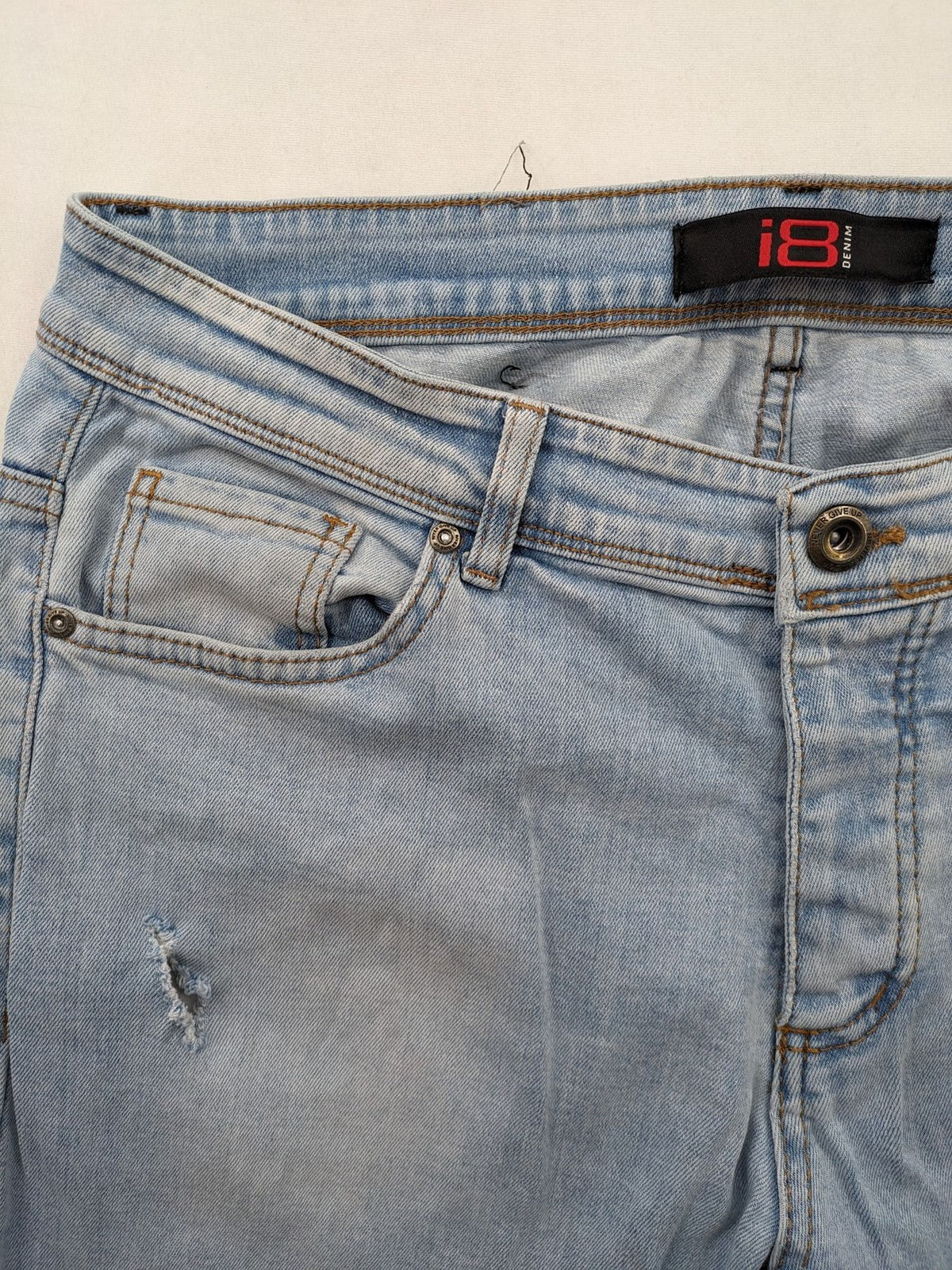 i8 Denim blue straight jeans destroyed look with frayed hems and classic button fly.