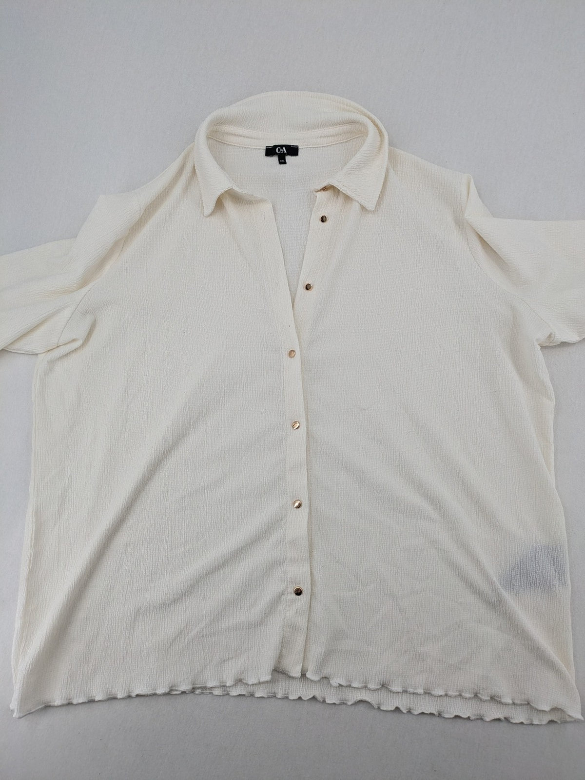 C&A cream blouse XXL textured crinkle fabric with gold button placket and wavy hem.