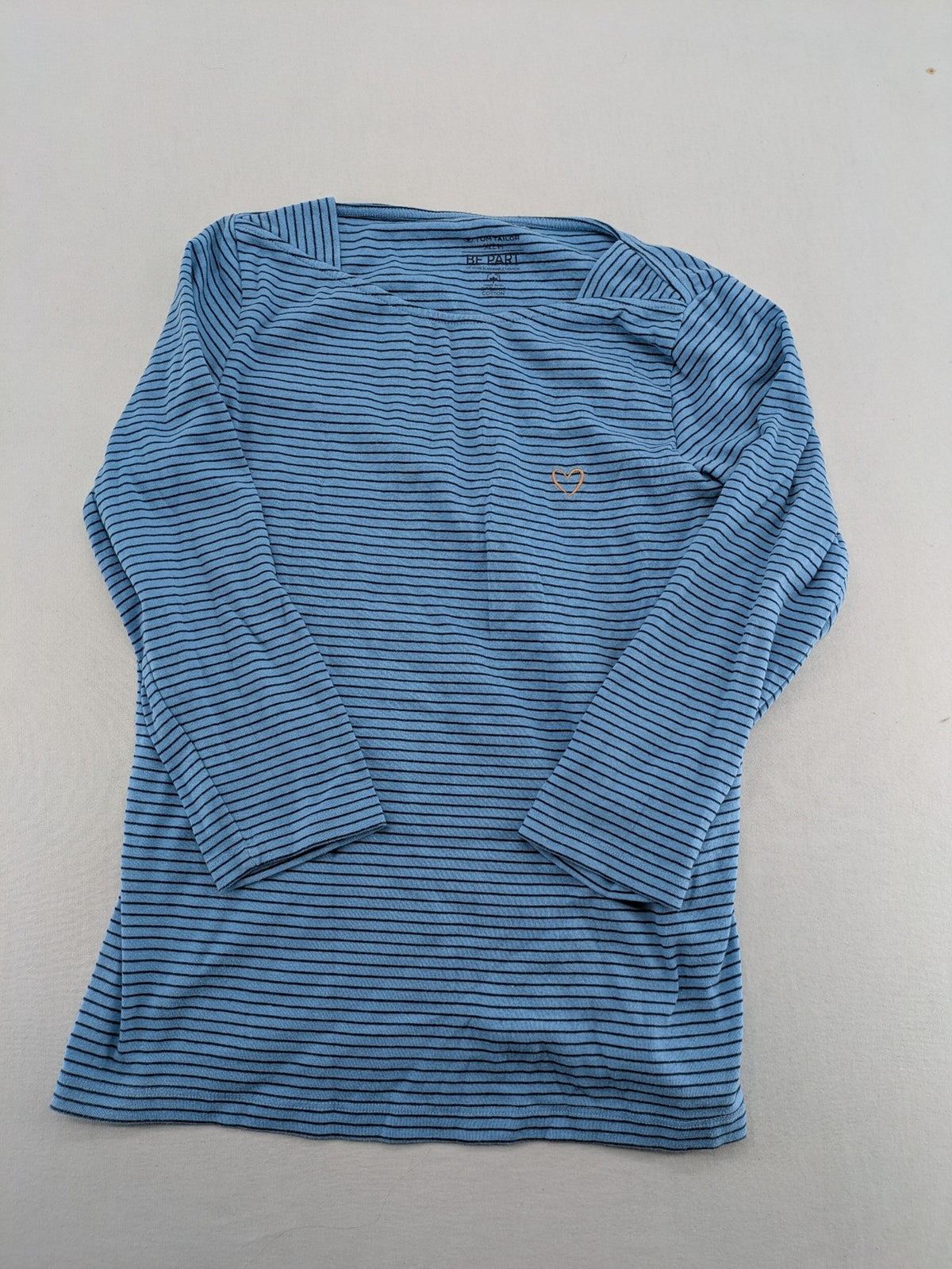 Tom Tailor blue striped top with gold heart emblem, made from organic cotton.