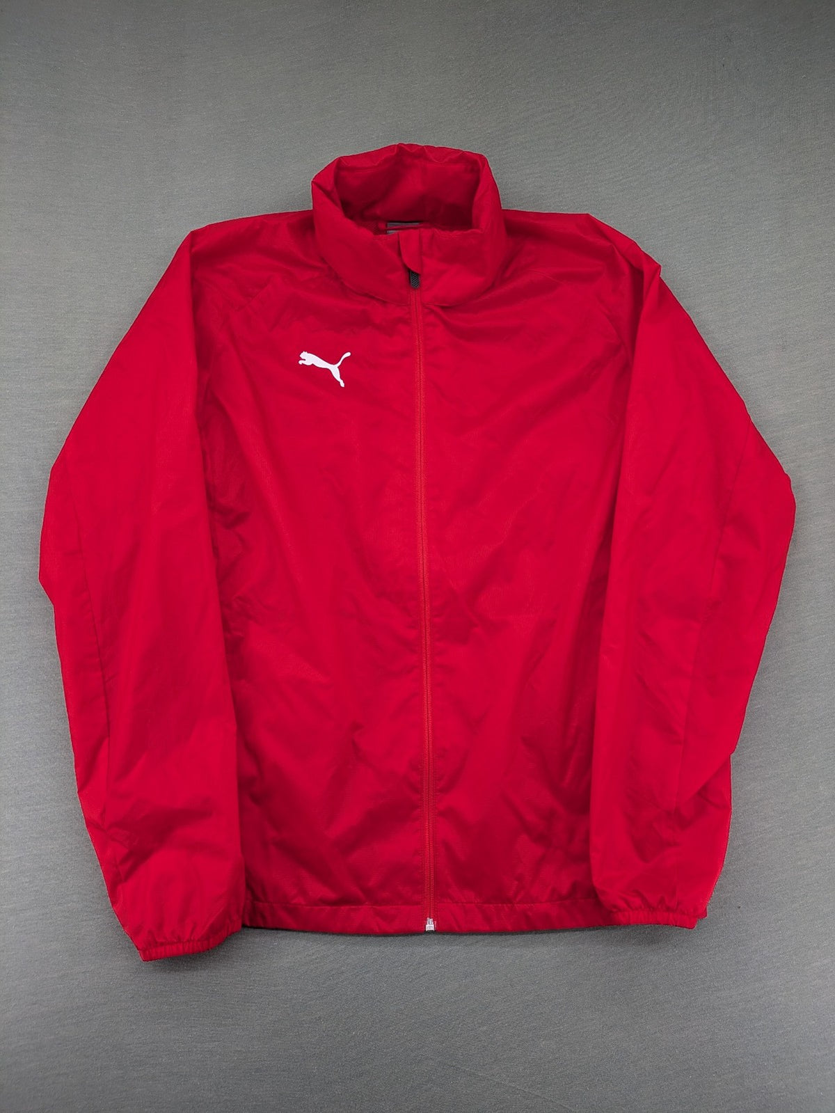 Puma red windbreaker jacket full zip with iconic logo and breathable mesh lining.