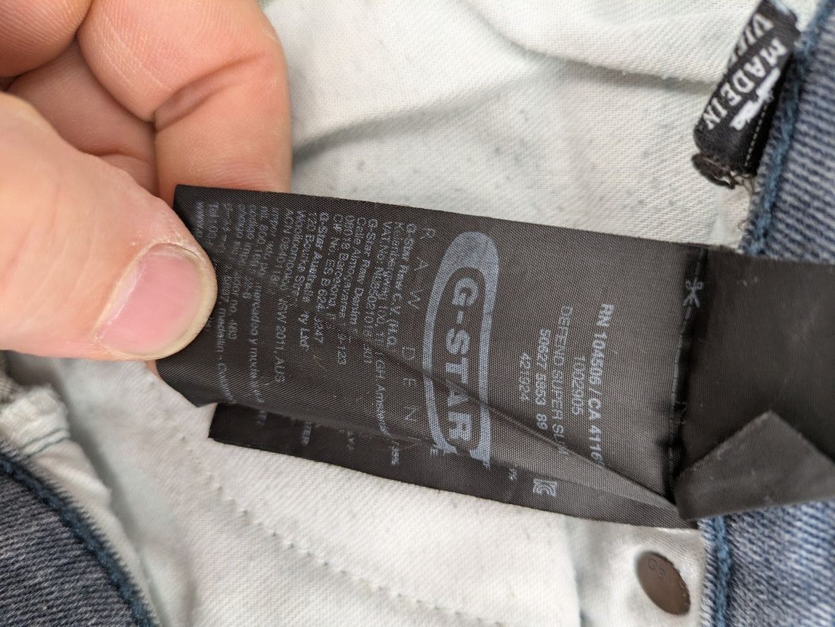 G-Star Raw grey denim straight jeans with classic button fly and subtle branding details.