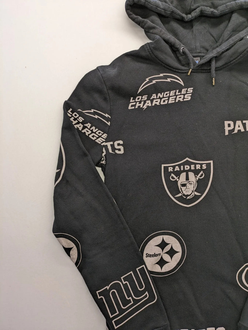 NFL black hoodie all-over team logo print, adjustable hood, cotton blend material.