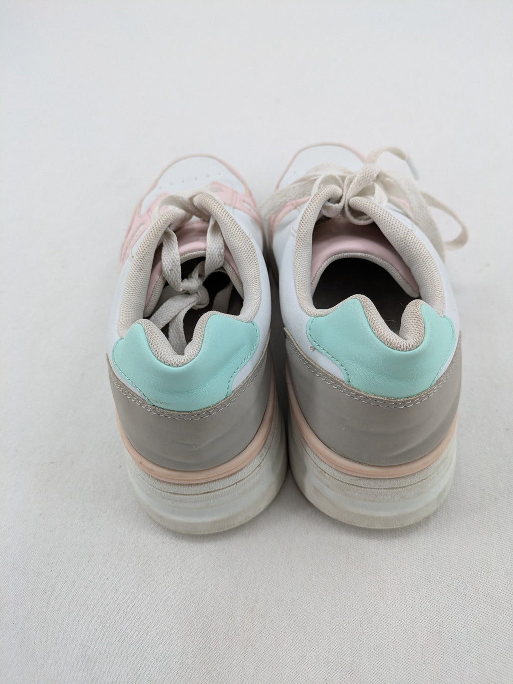 Graceland white sneakers with pink and mint green accents, low-top design, cushioned tongue.