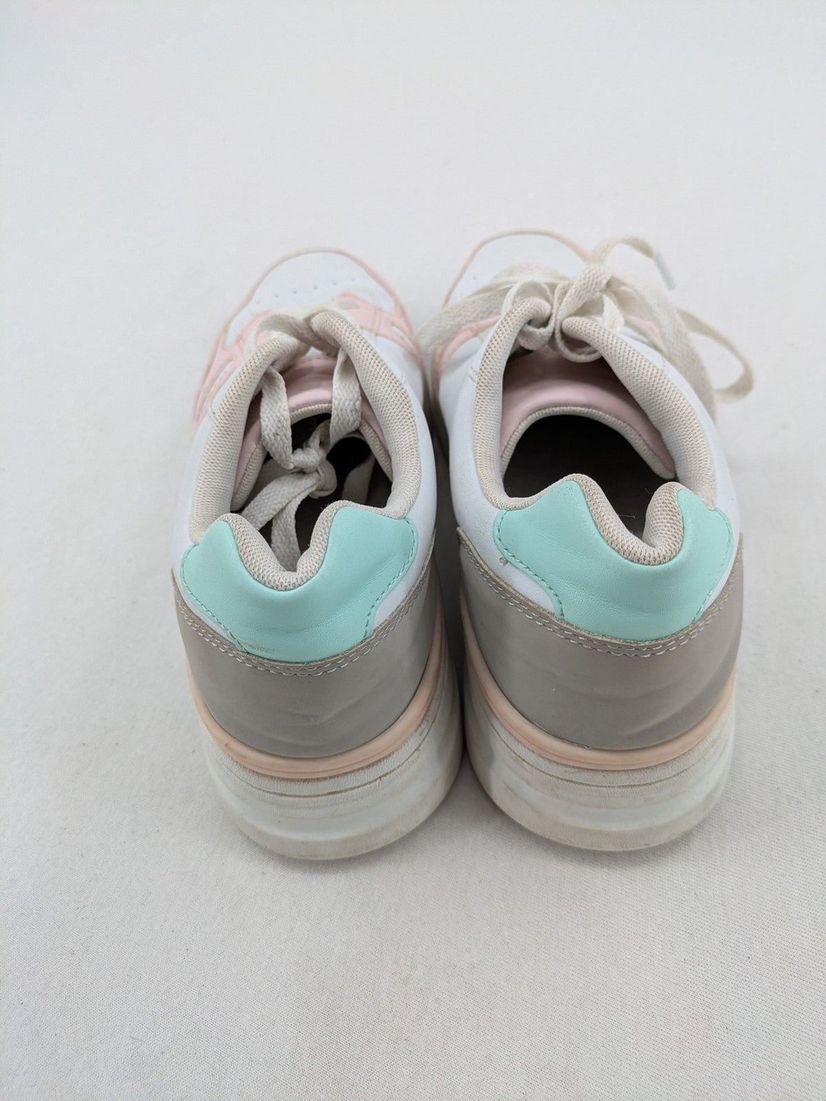 Graceland white sneakers with pink and mint green accents, low-top design, cushioned tongue.