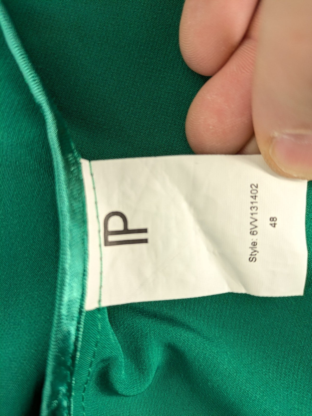 Promiss green blazer jacket single-button design with notch lapels and decorative pockets.