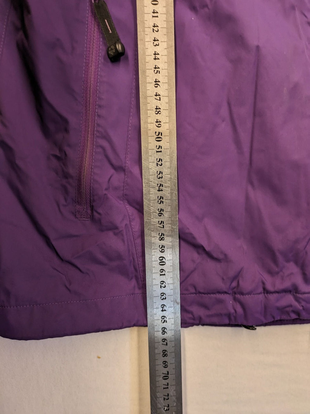 Jack Wolfskin purple outdoor jacket with adjustable hood and full zip, lightweight Stormlock material.