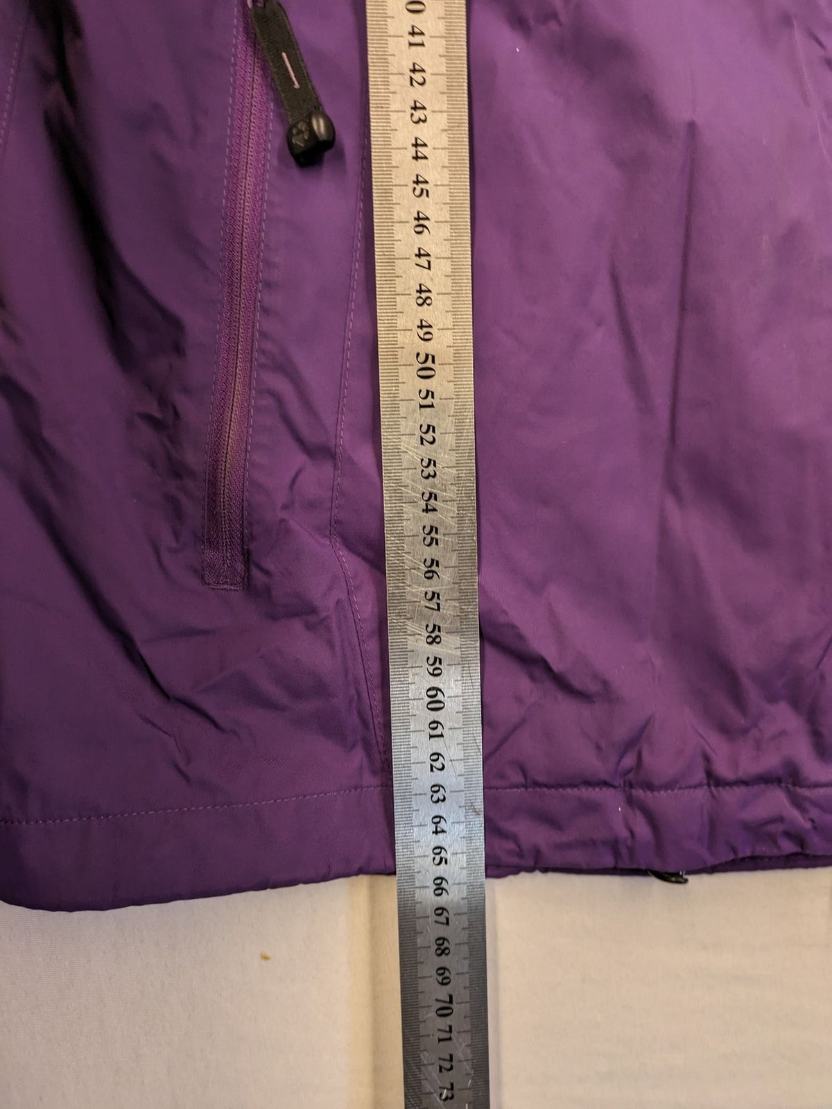 Jack Wolfskin purple outdoor jacket with adjustable hood and full zip, lightweight Stormlock material.