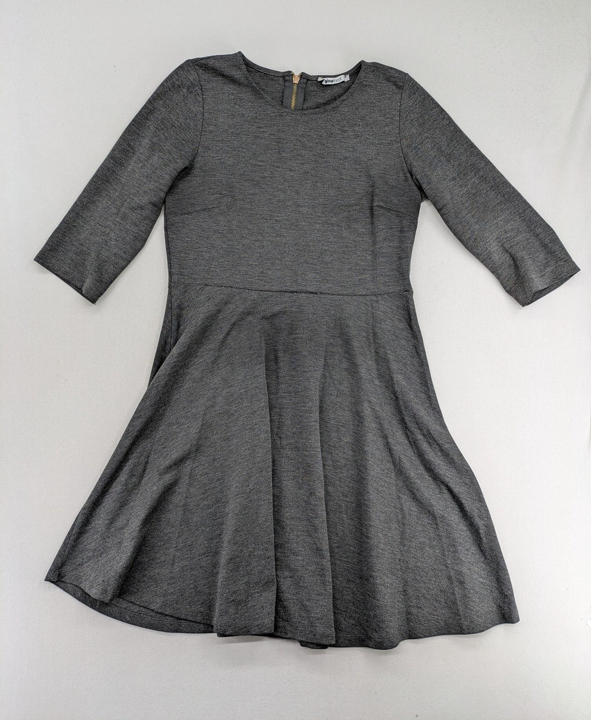 Ginatricot grey A-line skater dress with 3/4 sleeves and visible back zipper.