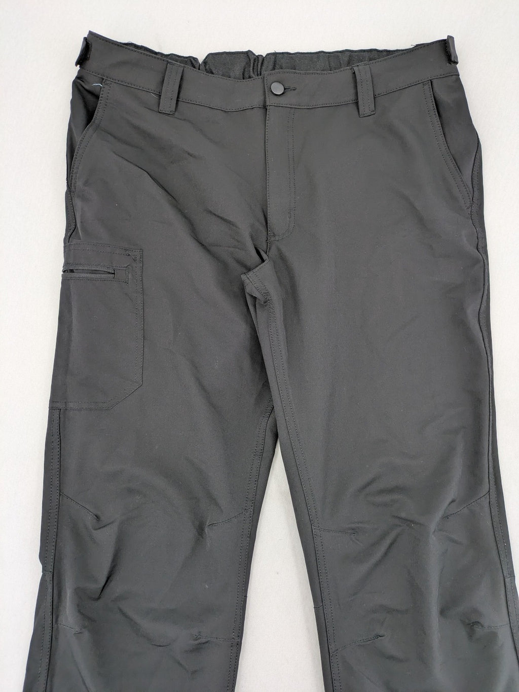 Outdoor grey trekking pants with zippered cargo pockets and durable stretch fabric.