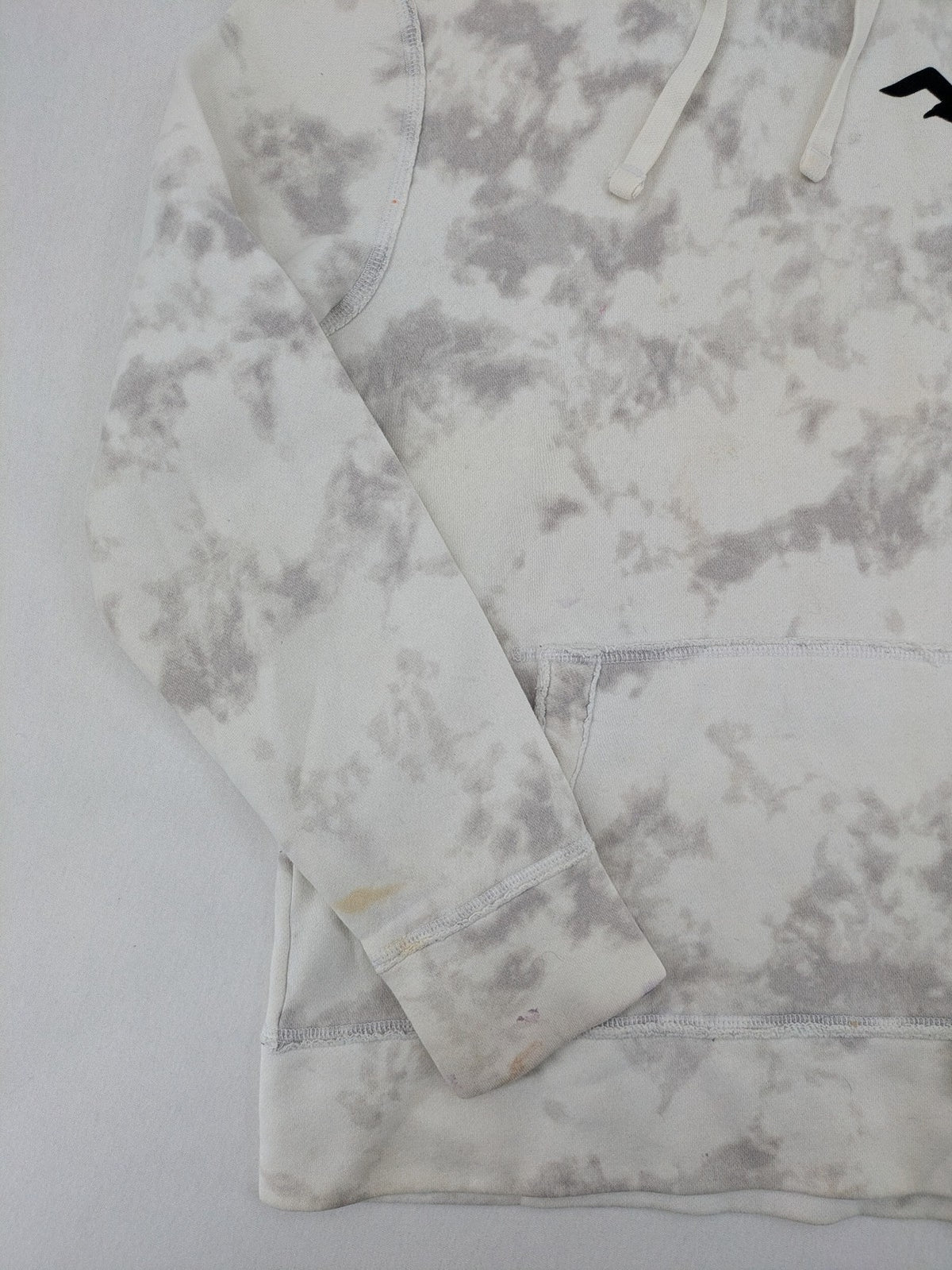 Hollister grey and white tie-dye hoodie with logo on chest, back, and sleeve.