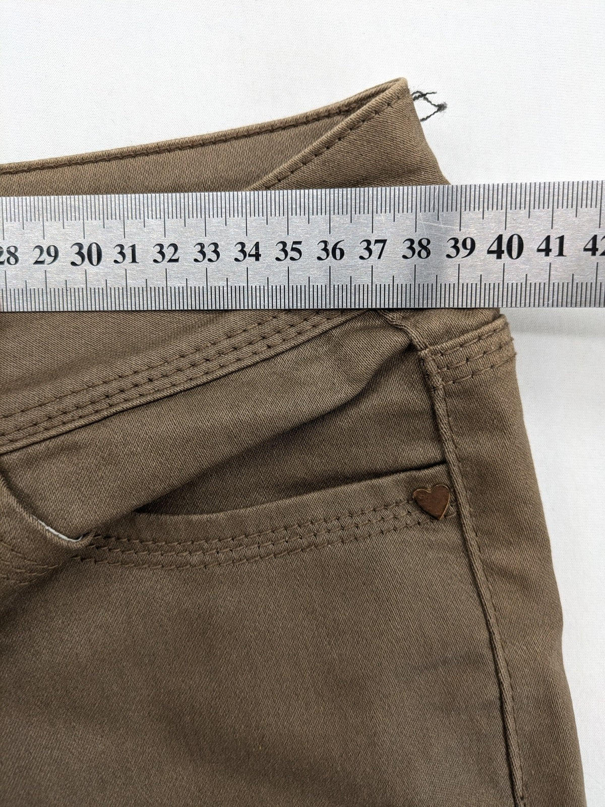 Vavell khaki skinny jeans five-pocket design with unique front zipper detail.