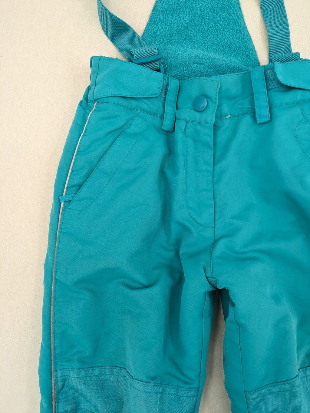 Topolino blue and turquoise snow pants with adjustable straps and fleece-lined bib.