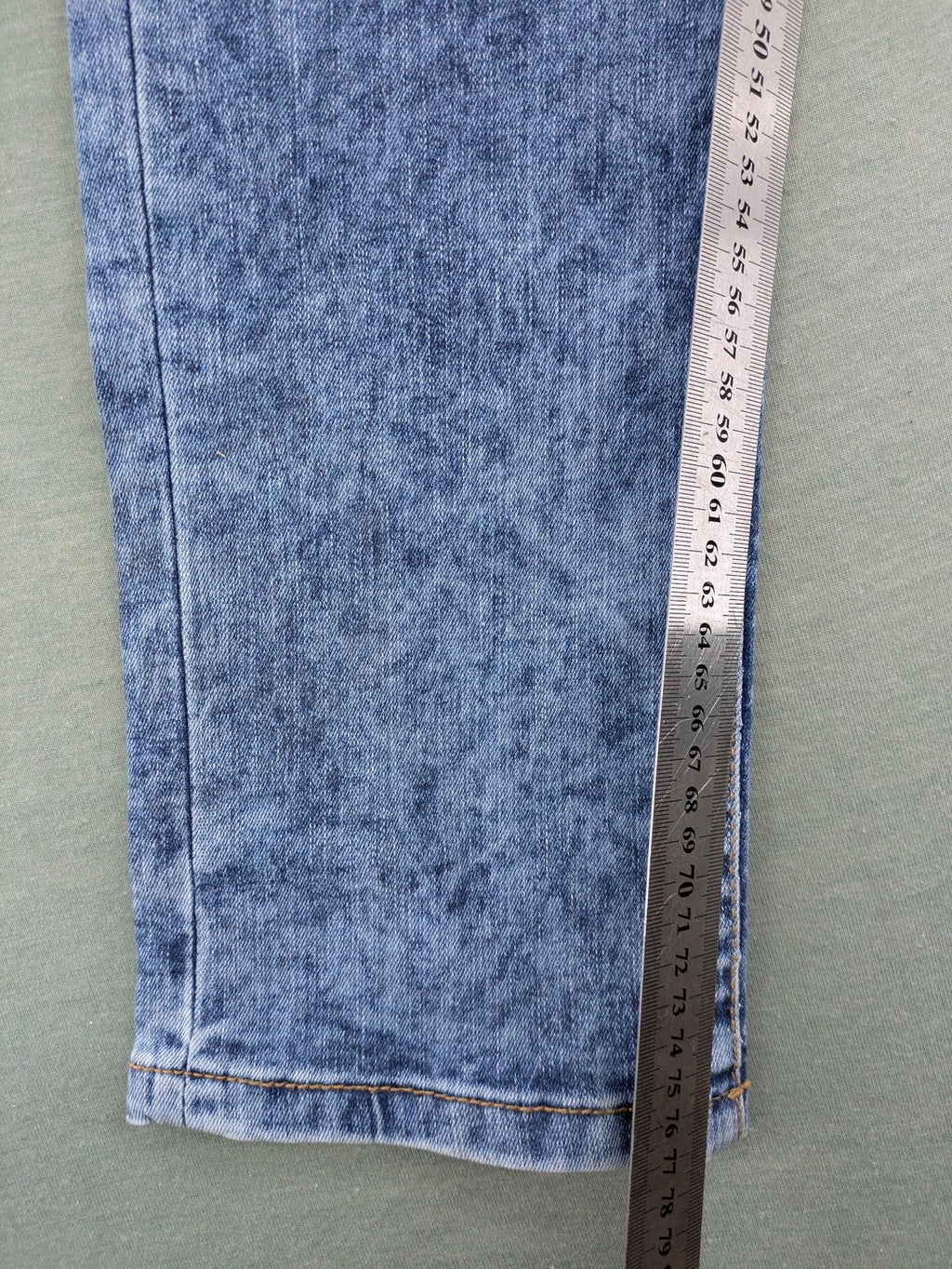 Janina blue slim fit jeans with acid wash, destroyed details, and button fly.