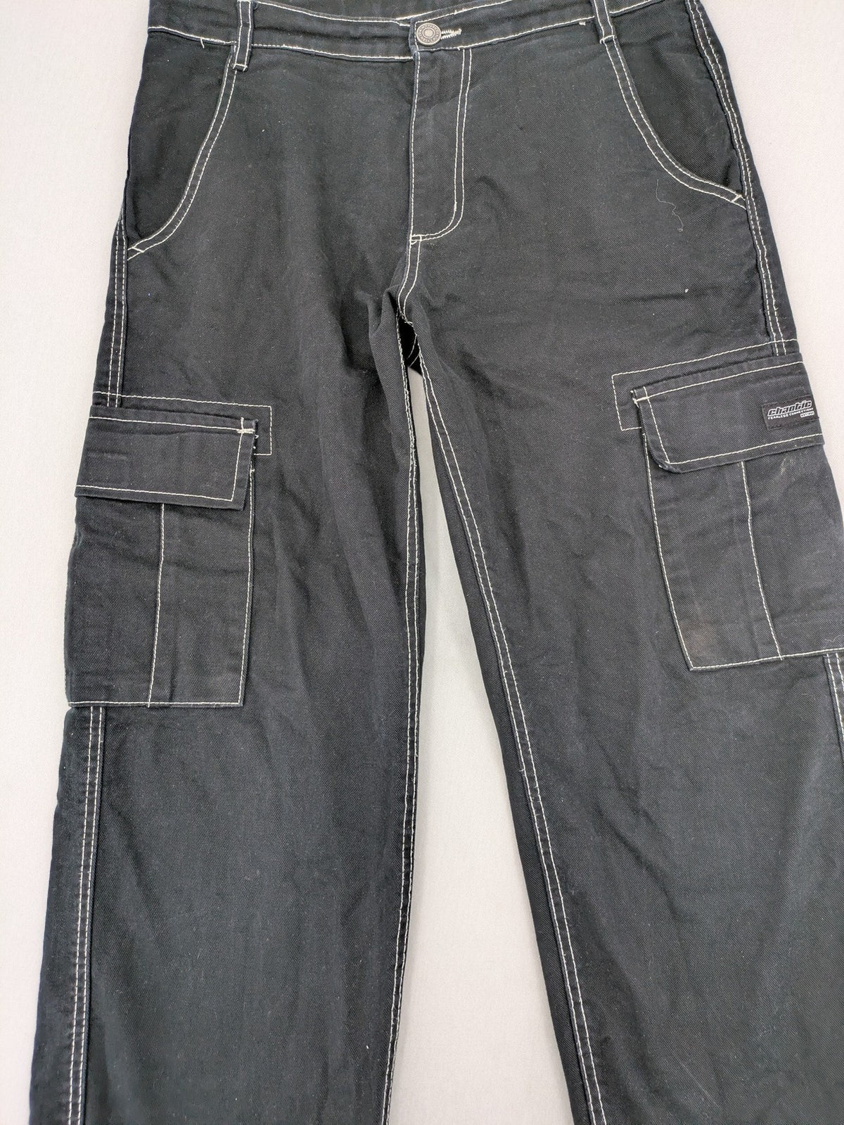 FSBN black baggy cargo pants with white contrast stitching and multiple pockets.