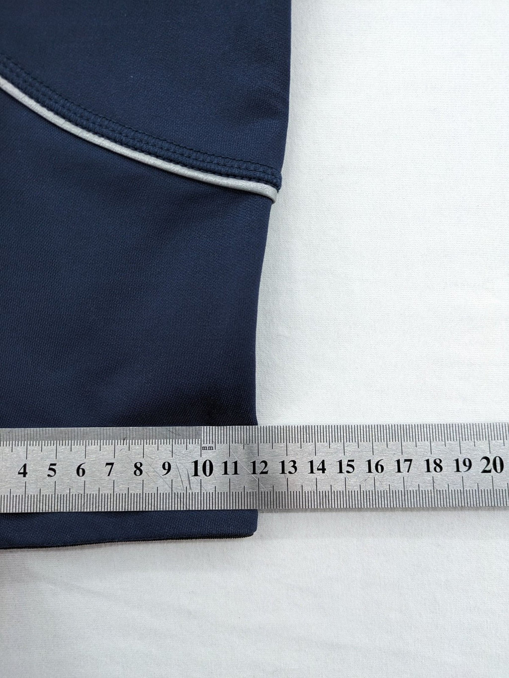 Crane Sports navy running tights with reflective details and zippered ankle openings.