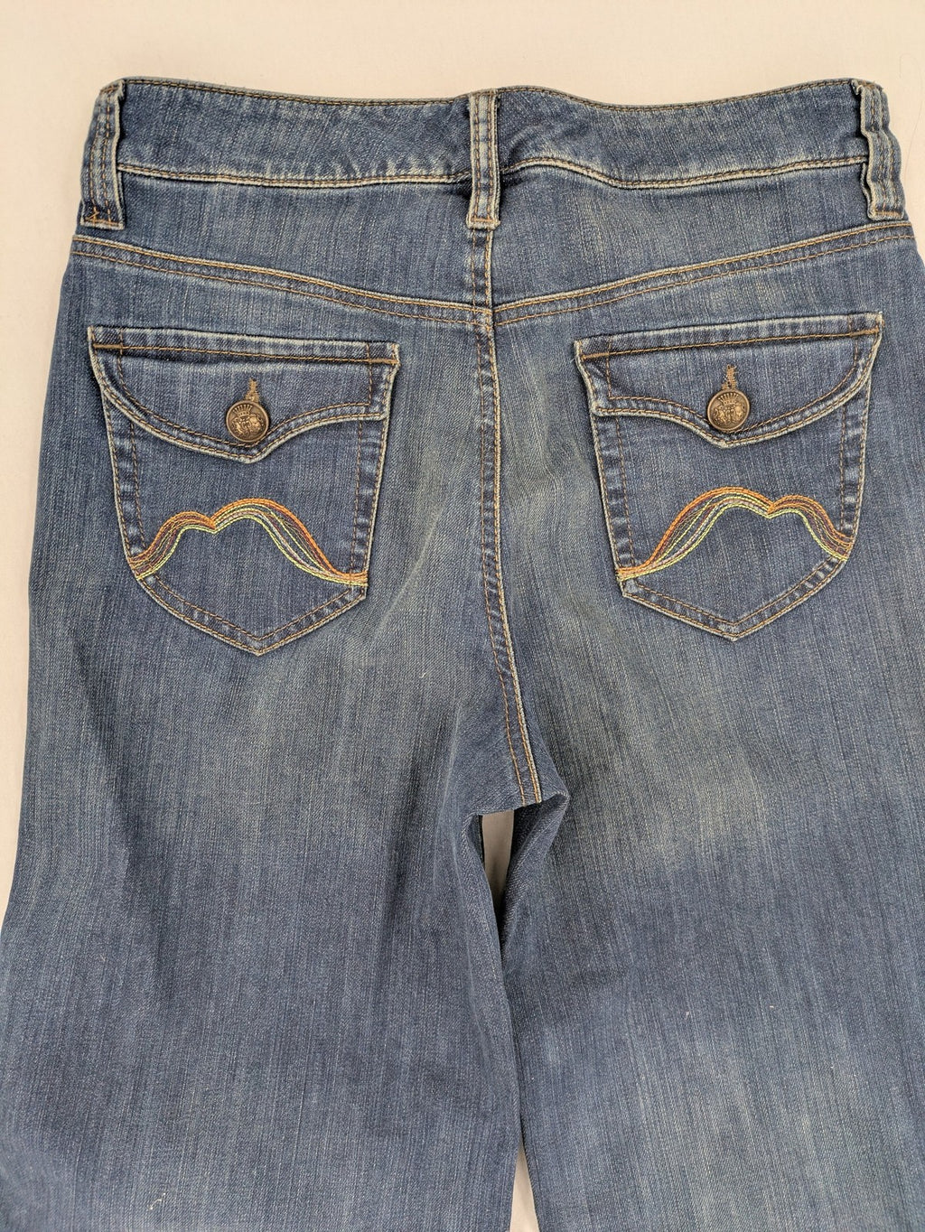 Rosner blue wide leg jeans with colorful embroidery on back pockets.