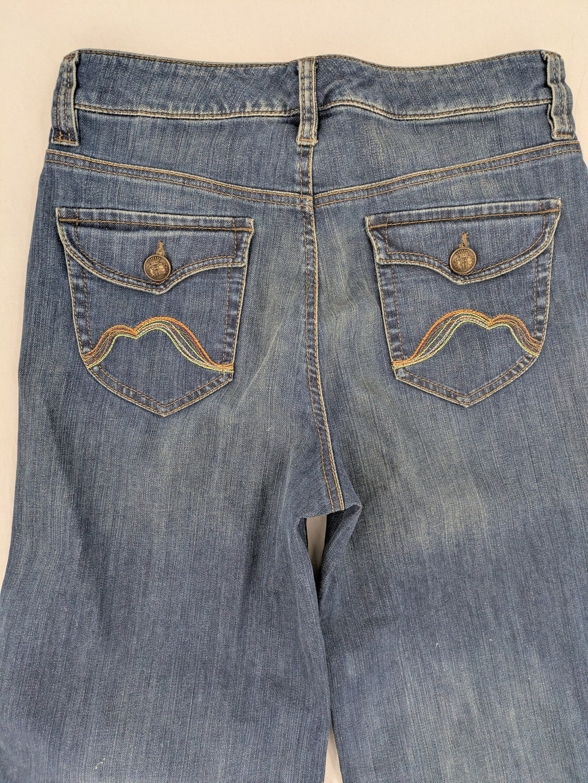 Rosner blue wide leg jeans with colorful embroidery on back pockets.