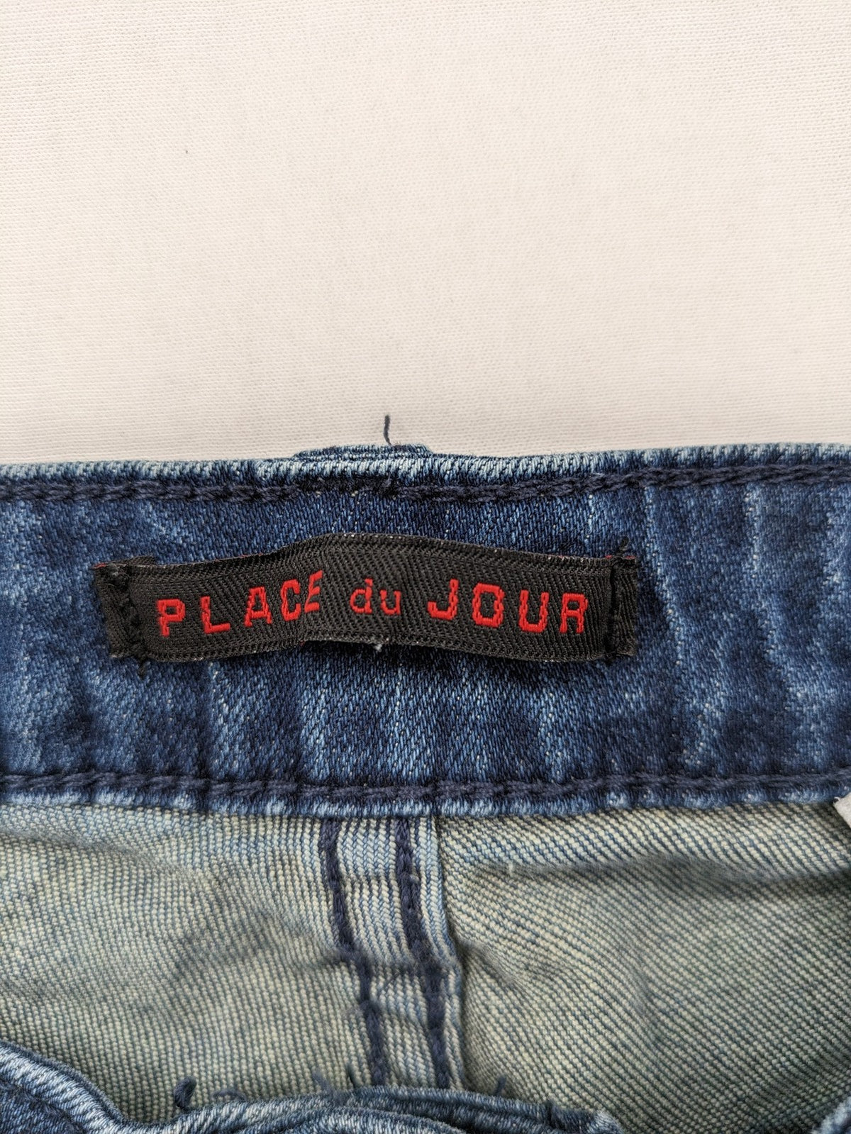 Place du Jour blue biker jeans with zippers, used-look wash, and star rivet detail.