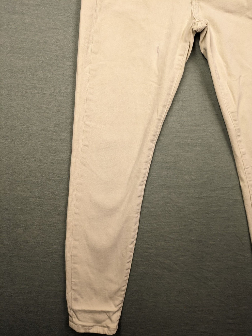 Tommy Jeans beige high rise skinny ankle jeans with logo patch and stretch fabric.