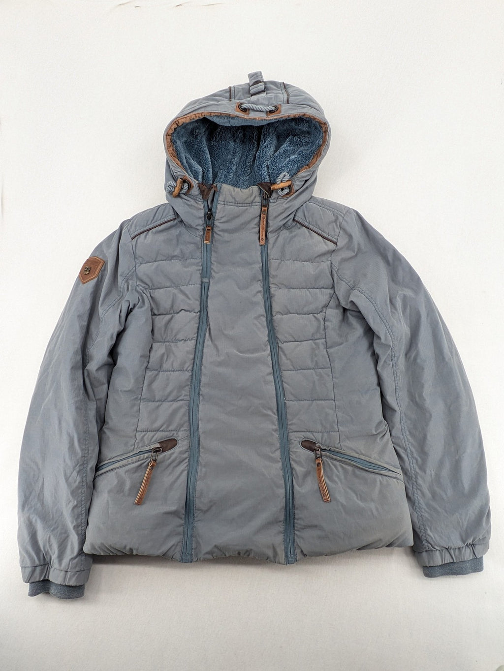 Naketano blue jacket with teddy fleece lining, hood, and leather appliqués.