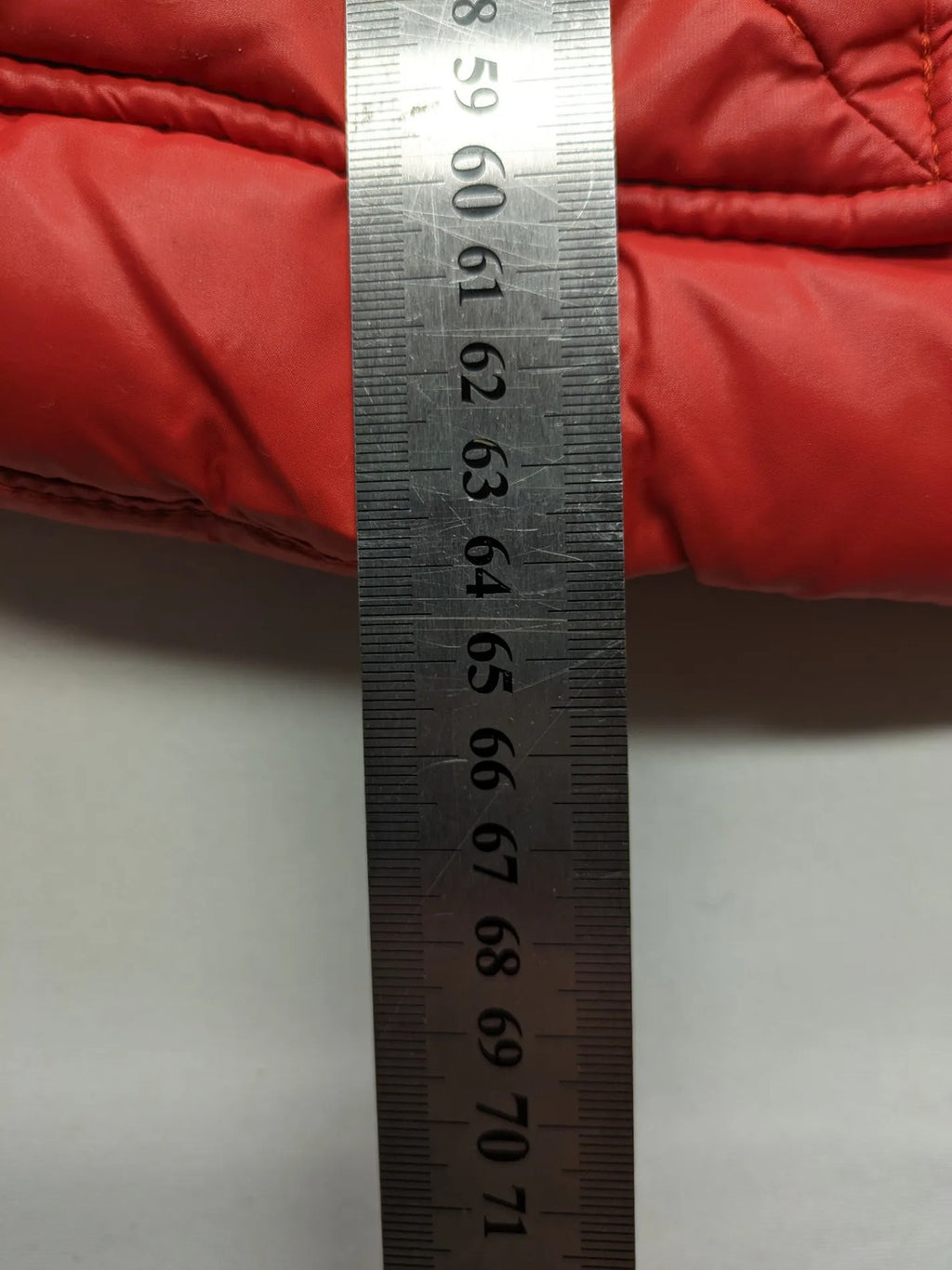 Hilfiger Denim red down jacket with quilted design, stand collar, and zip closure.