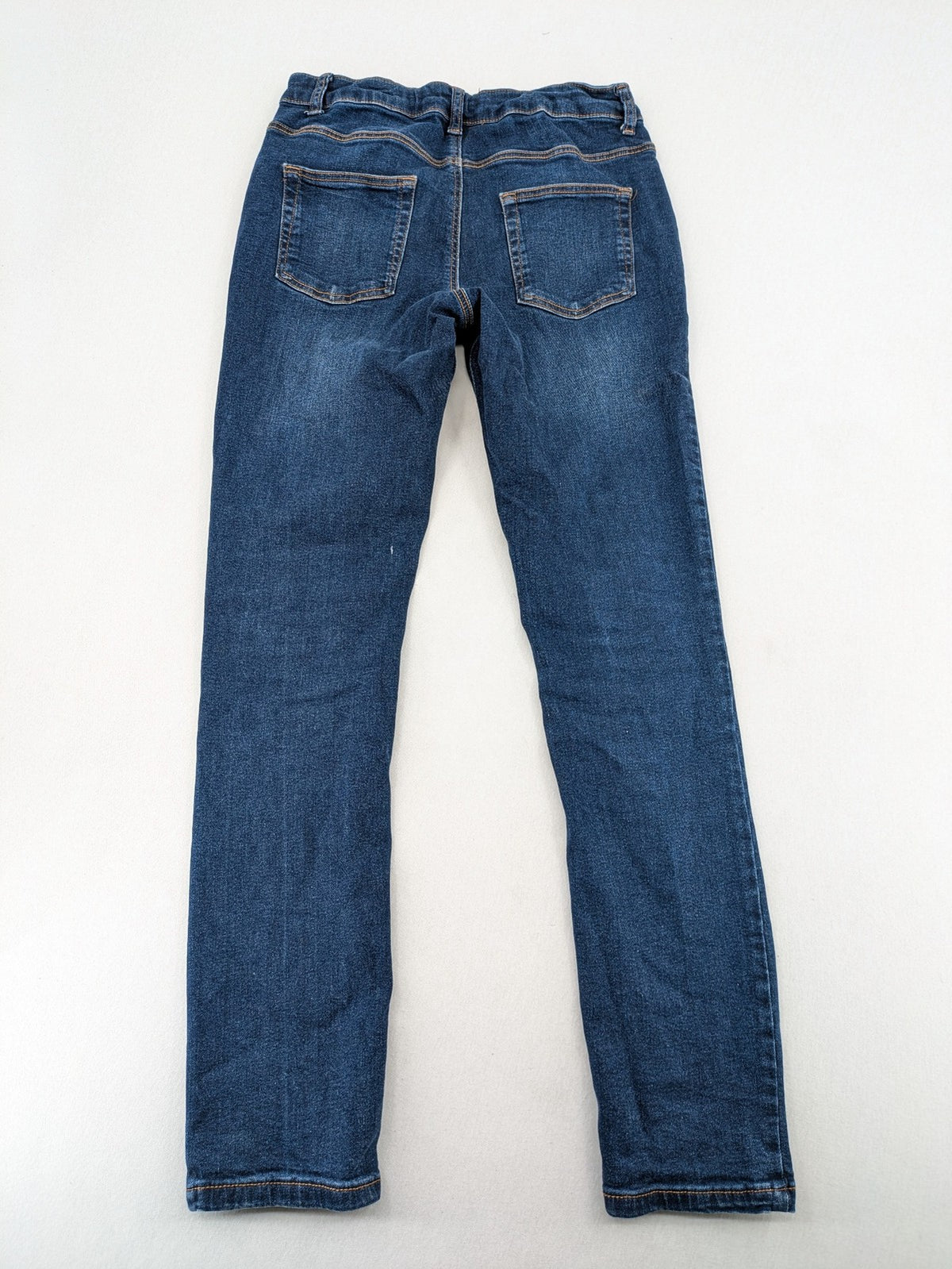 Denim & Co. blue skinny stretch jeans, five-pocket design, dark wash, durable material.