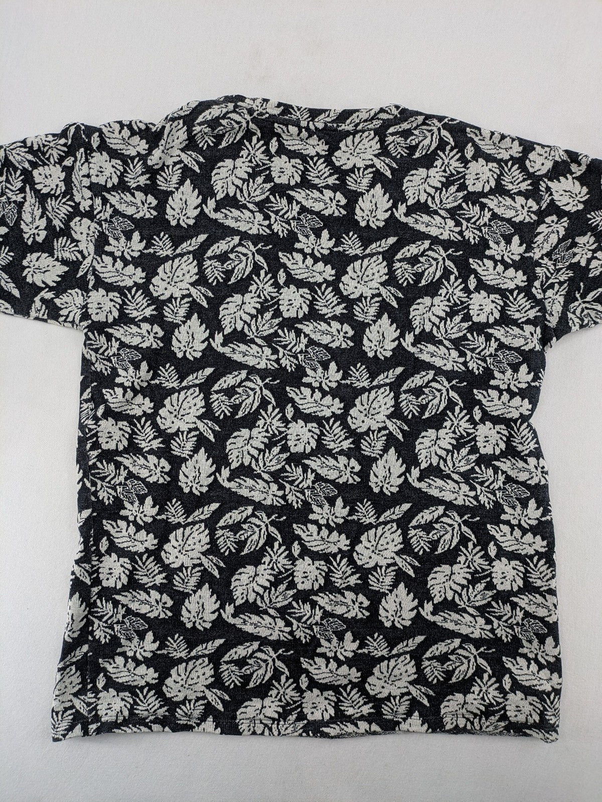 Zara Man black and white t-shirt with allover leaf print and textured knit fabric.