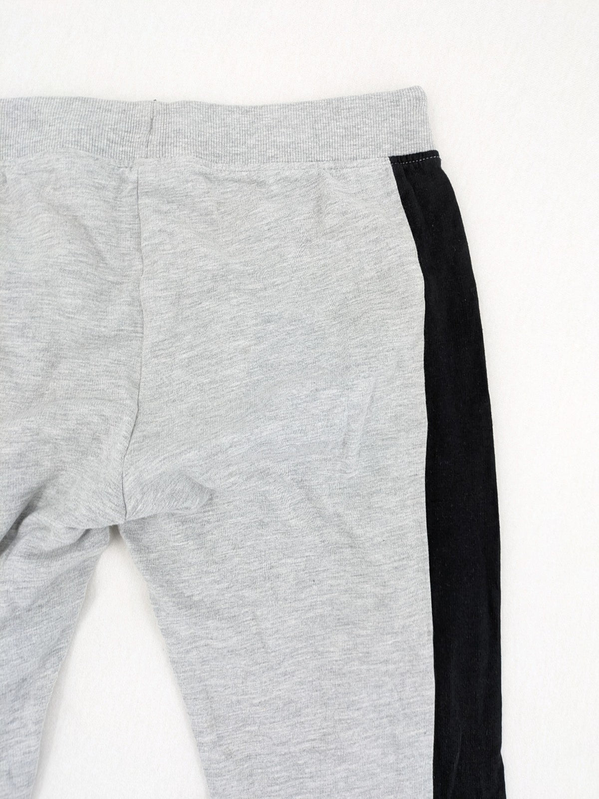 Fortnite pants grey with black side stripes and large logo print, cotton blend material.