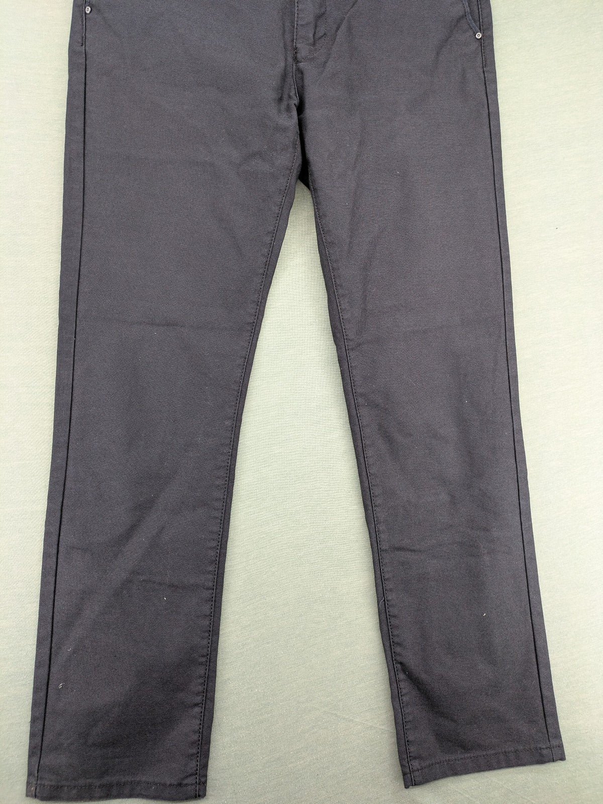 Rooney grey chino pants with checkered waistband and buttoned back pockets.