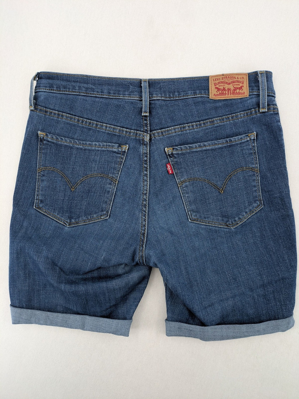 Levi's blue denim Bermuda shorts with rolled cuffs and classic 5-pocket design.