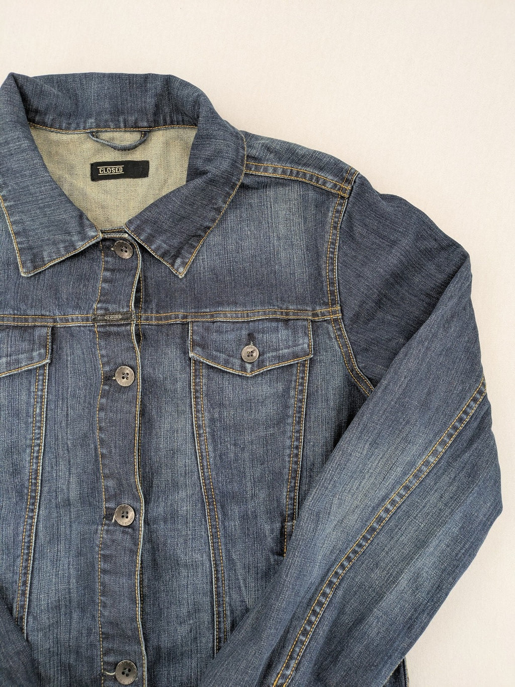 CLOSED blue denim trucker jacket with button front and two chest pockets.