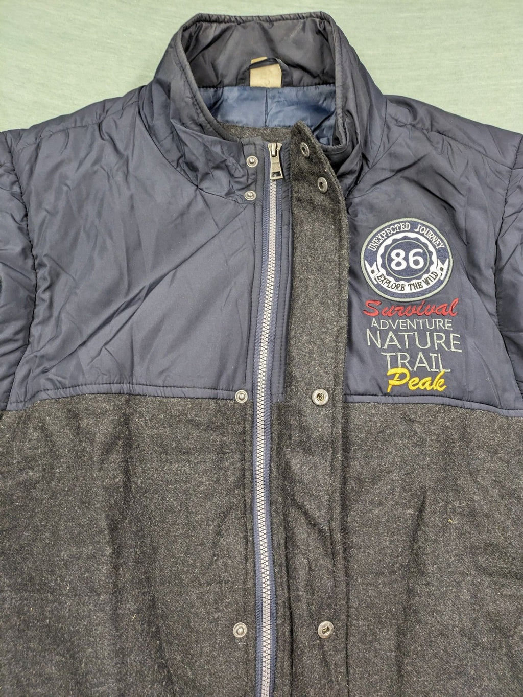 Men Plus grey and navy quilted vest with full zip and snap button placket.