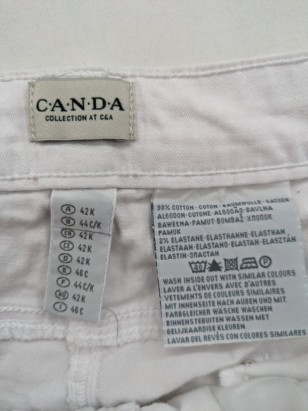 Canda white capri pants cotton-elastane blend with decorative zippers and stylish pockets.
