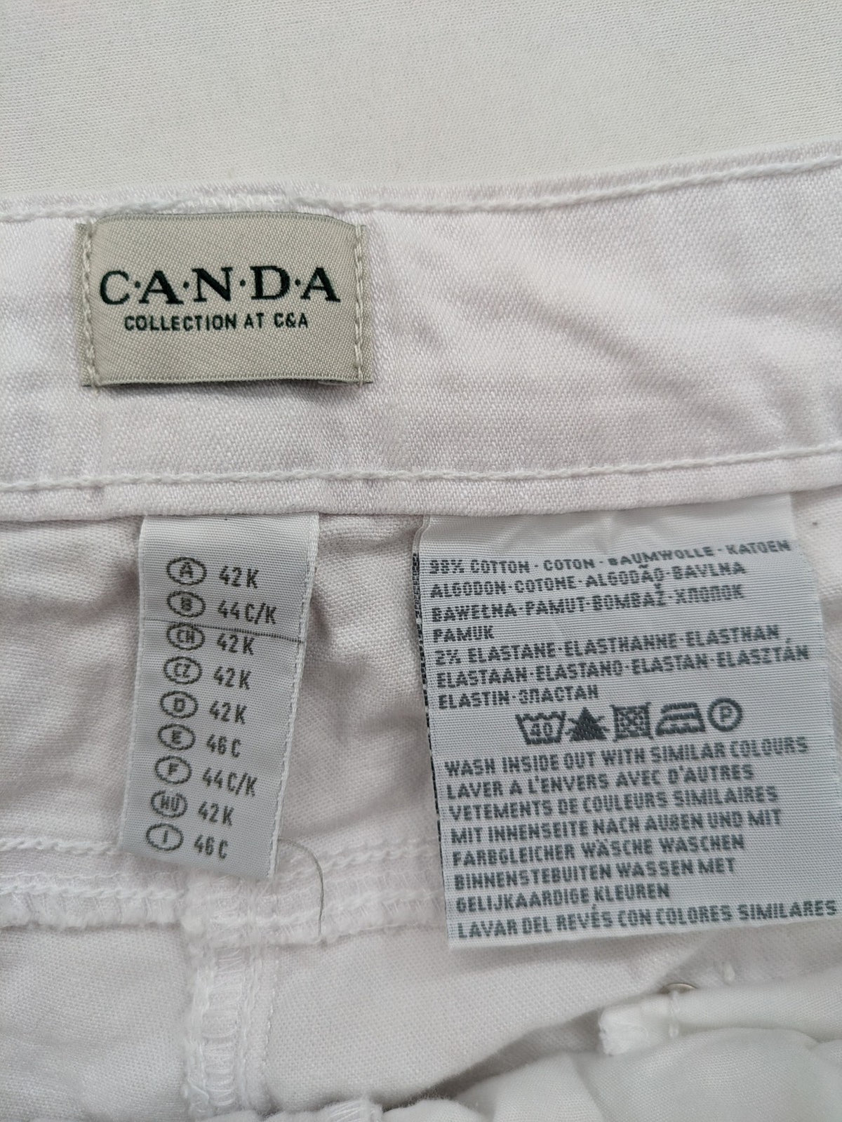 Canda white capri pants cotton-elastane blend with decorative zippers and stylish pockets.