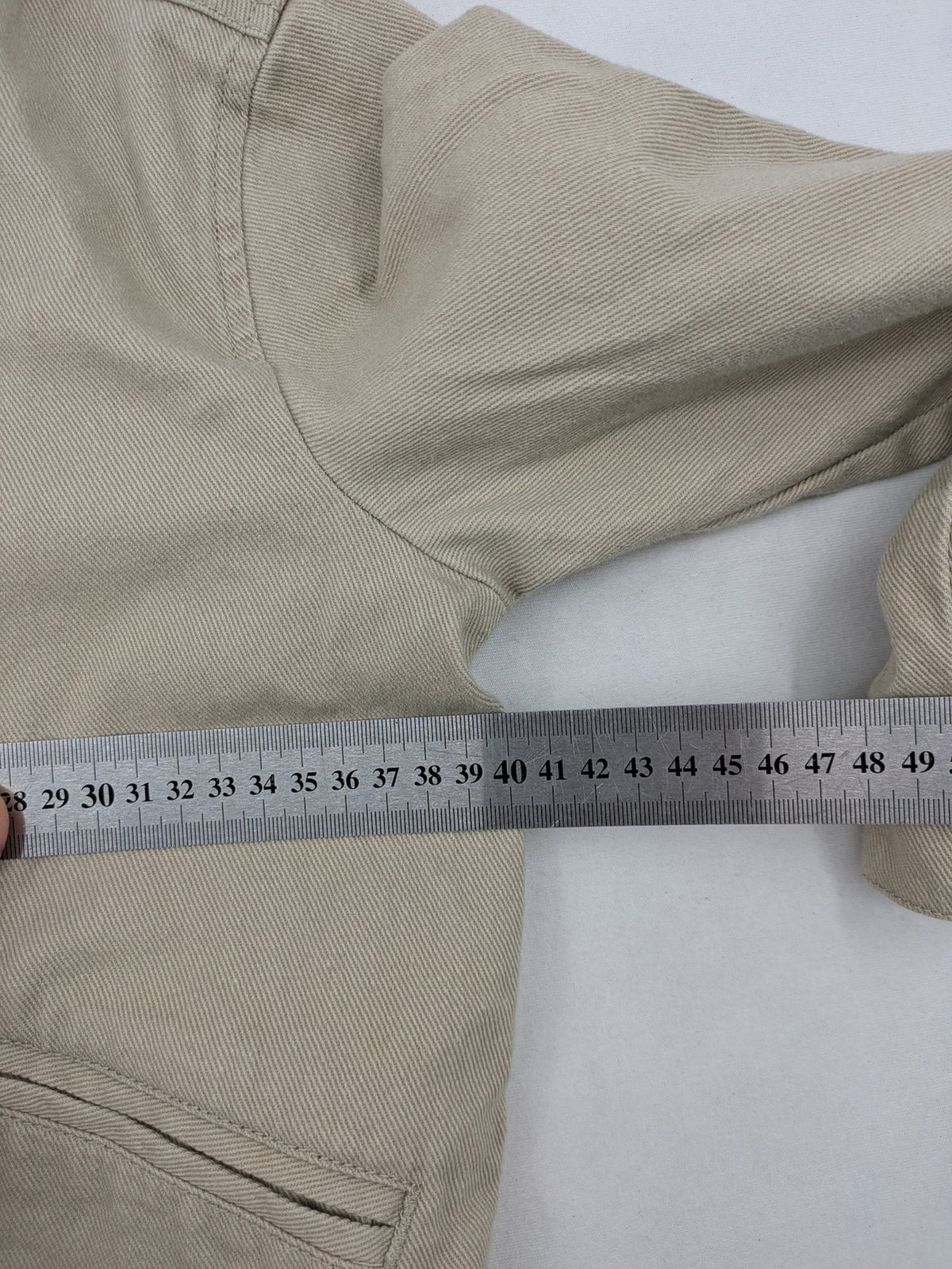 H&M beige twill coat with full zip, classic collar, and practical pockets.