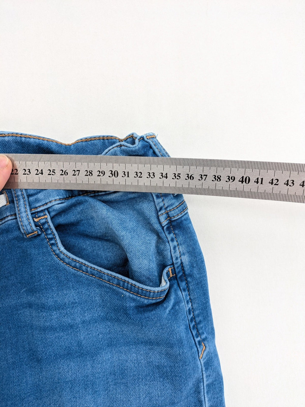 H&M blue straight jeans with elastic waistband and white drawstring, casual jogger style.