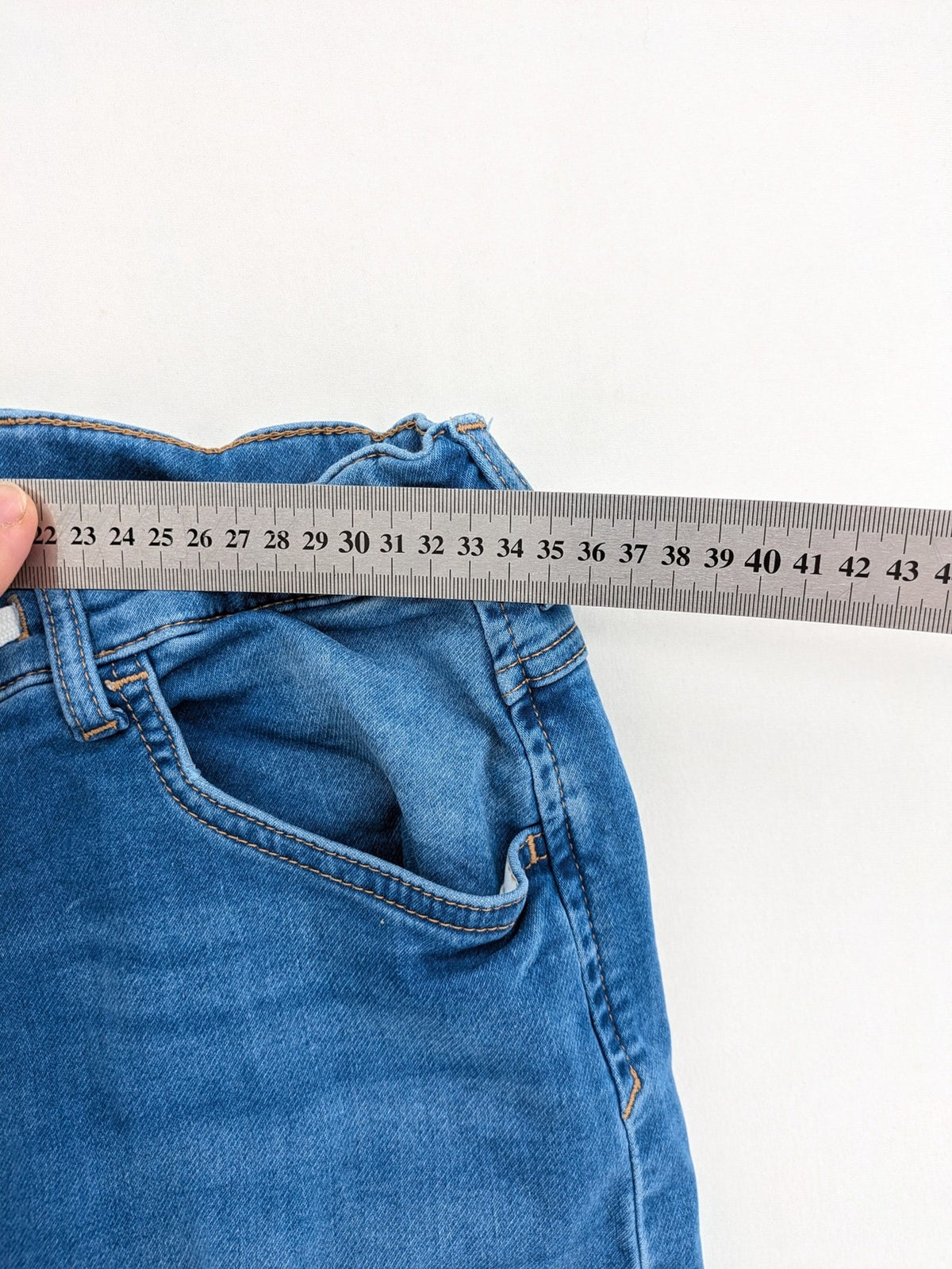 H&M blue straight jeans with elastic waistband and white drawstring, casual jogger style.