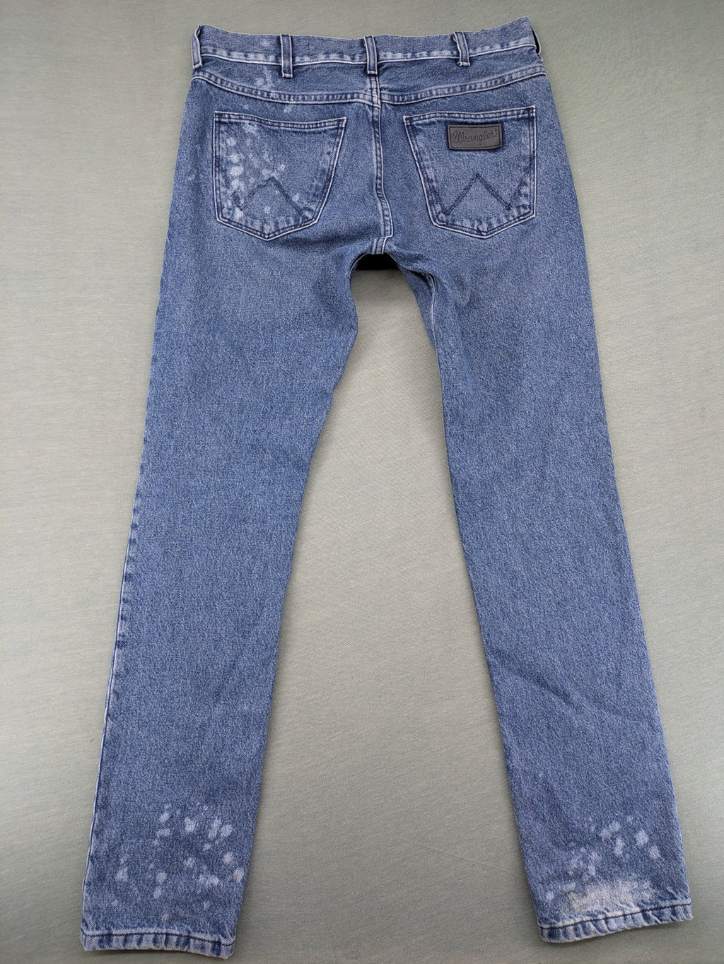 Wrangler blue straight jeans with button fly and classic 5-pocket design.