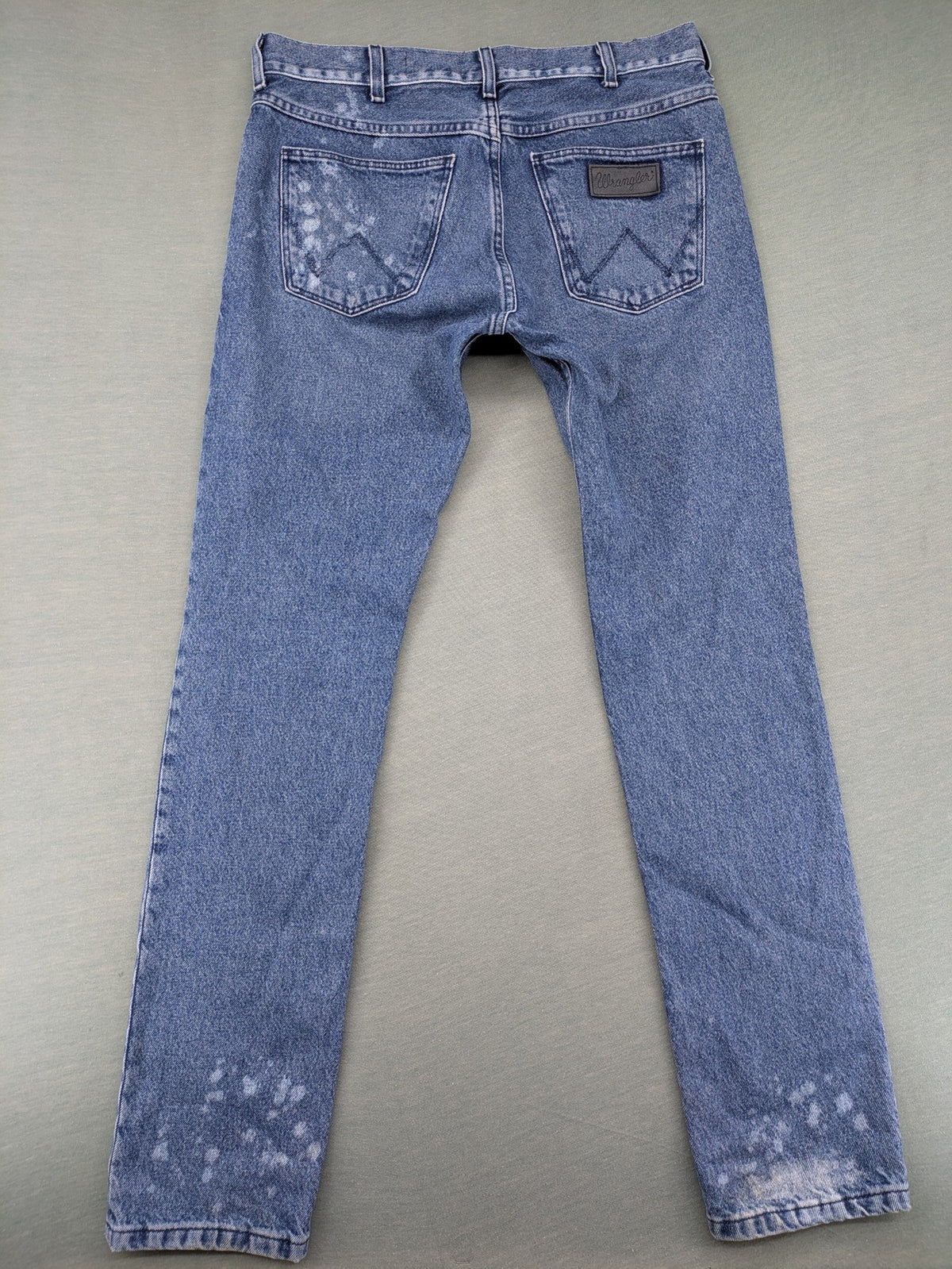 Wrangler blue straight jeans with button fly and classic 5-pocket design.