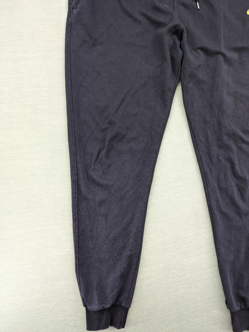 Nike F.C. grey jogger pants with elastic waistband, side pockets, and embroidered Swoosh logo.