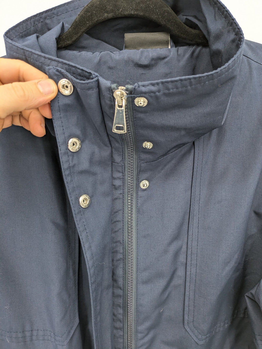 Janina navy anorak jacket with high collar and adjustable drawstring waist.