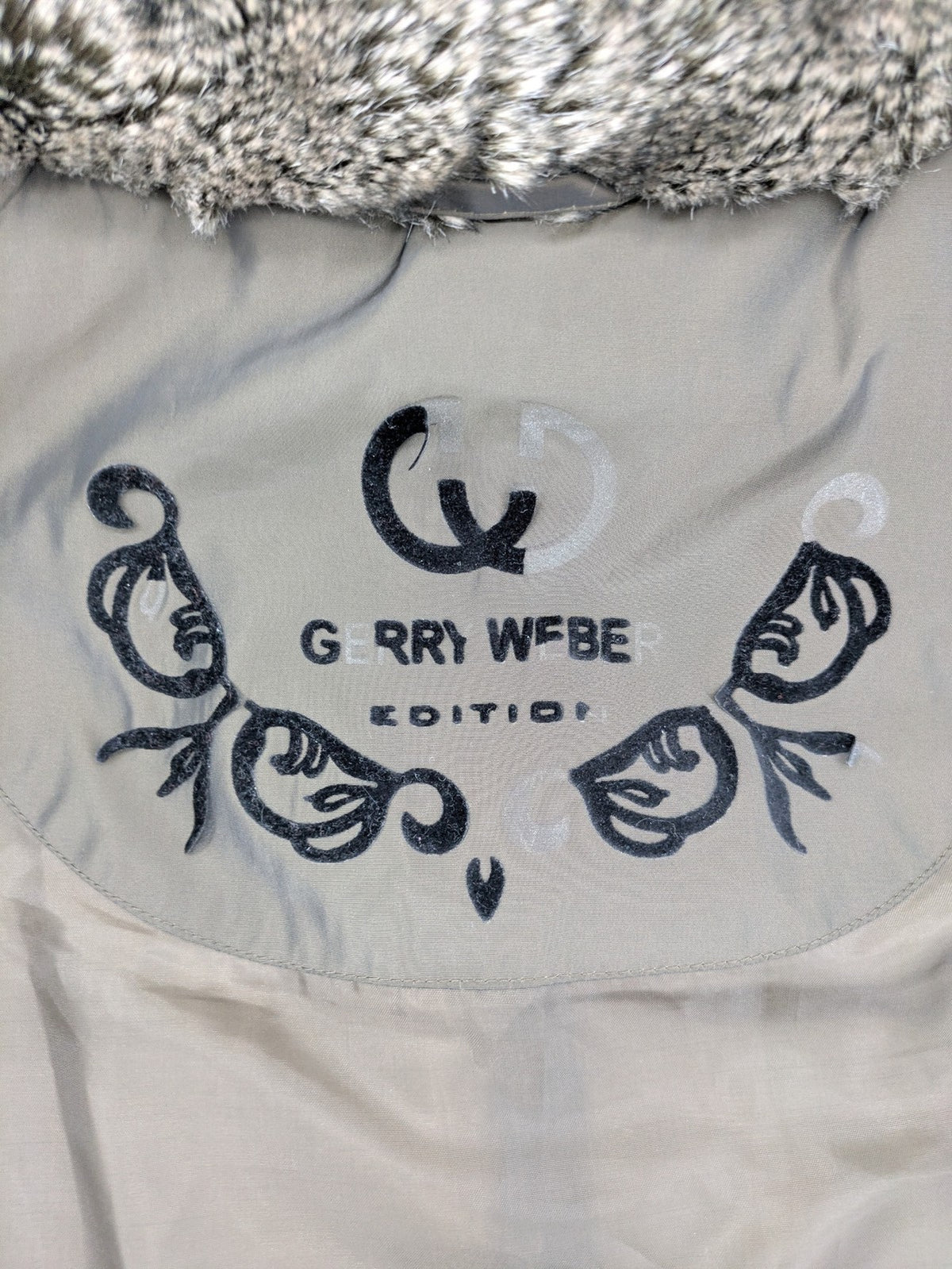 Gerry Weber Edition grey quilted coat with faux fur collar and metal toggle closures.