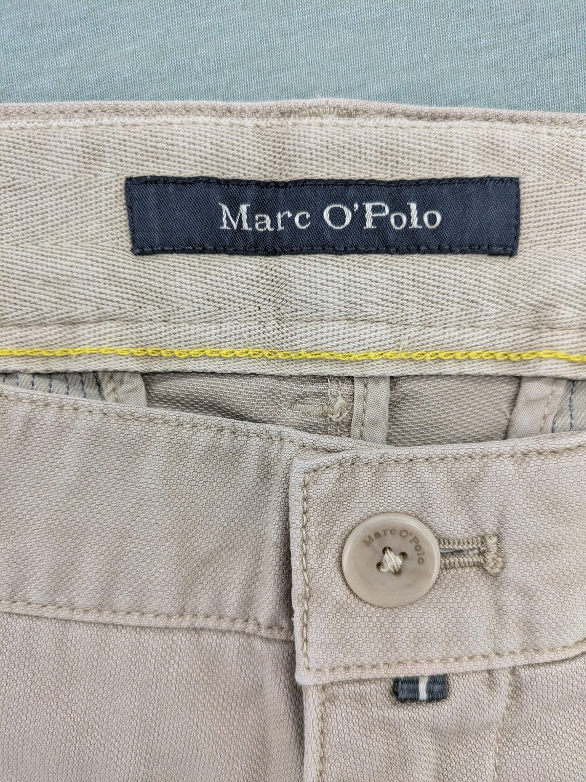 Marc O'Polo beige tapered fit chino pants, soft cotton stretch fabric, modern silhouette.