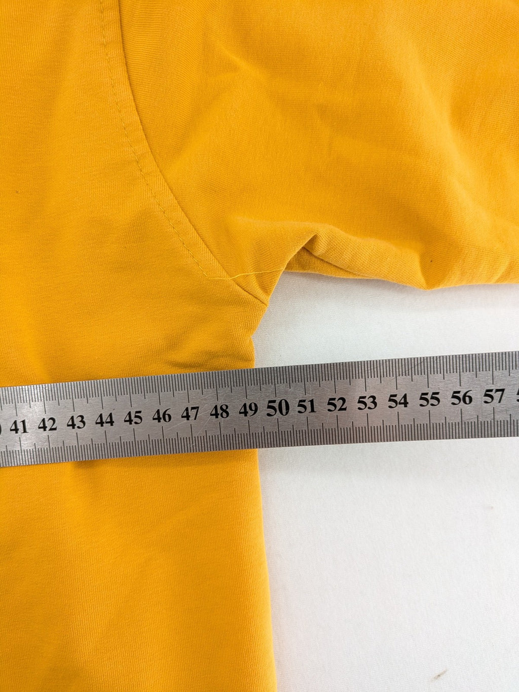 Columbia yellow turtle neck jumper with iconic logo, ribbed cuffs, and soft cotton material.