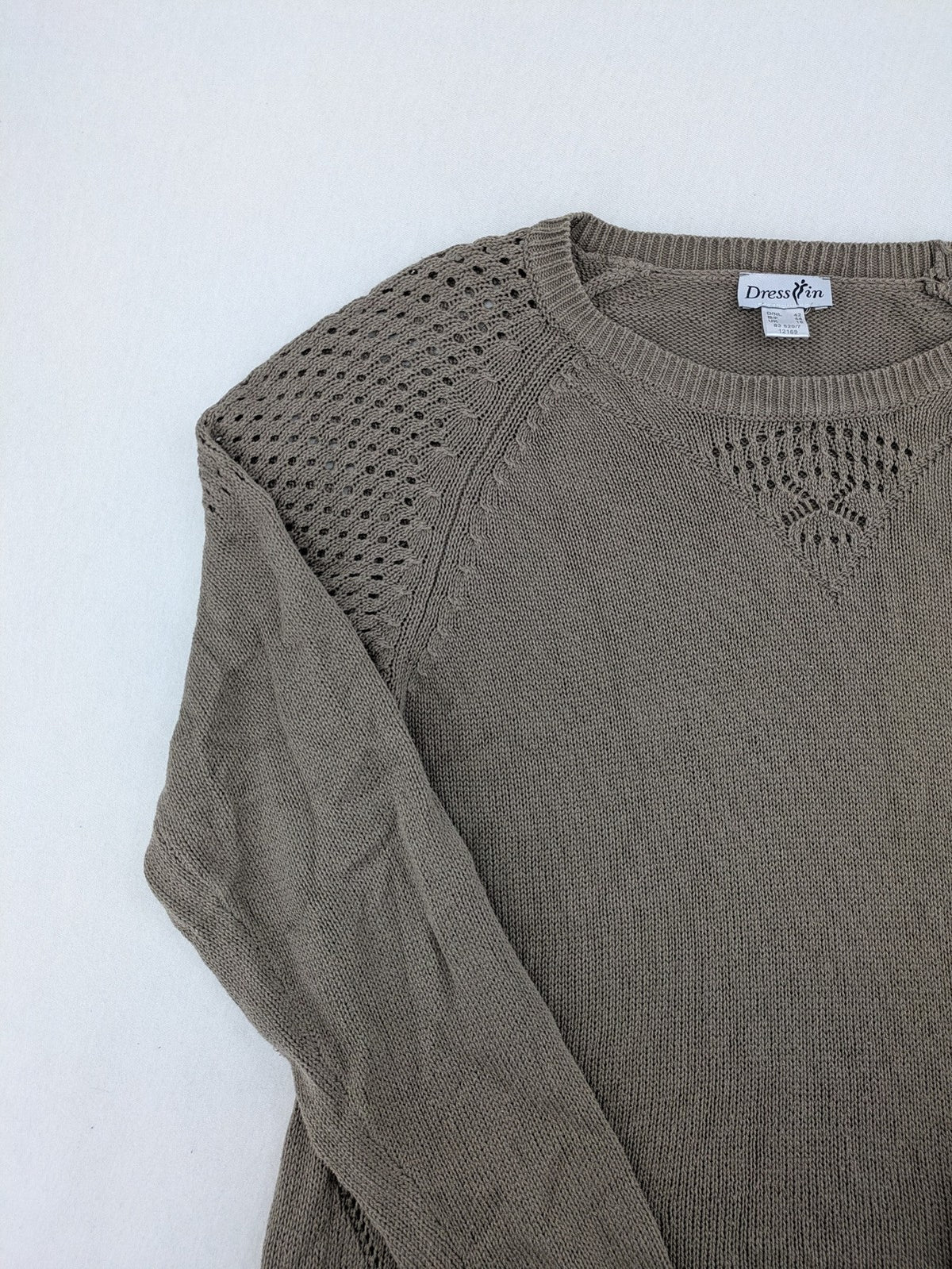 Dressin brown knit jumper with decorative open-knit details and comfortable fit.